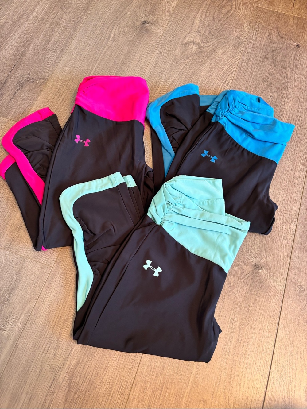 Under Armour Women's Black Leggings with Pink, Teal, and Blue Accents